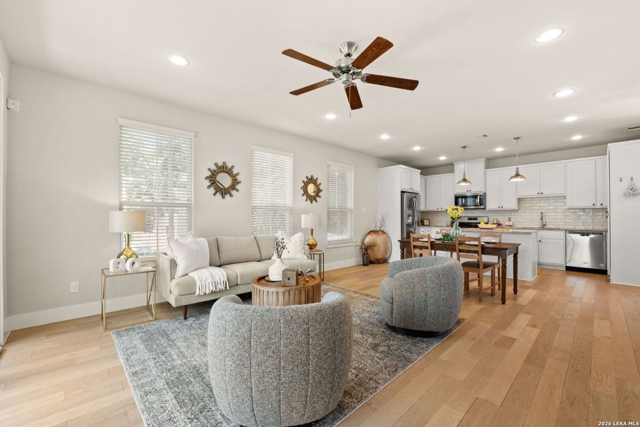 Staged open living room and kitchen at 202 Claremont Ave #102