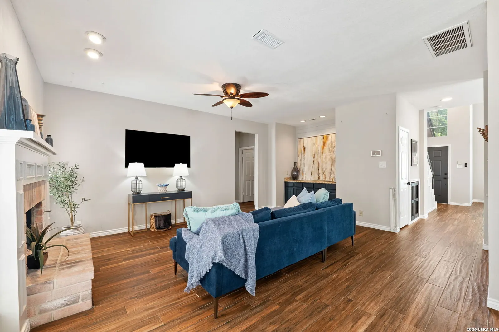 Staged living room with blue sofa and clear traffic flow