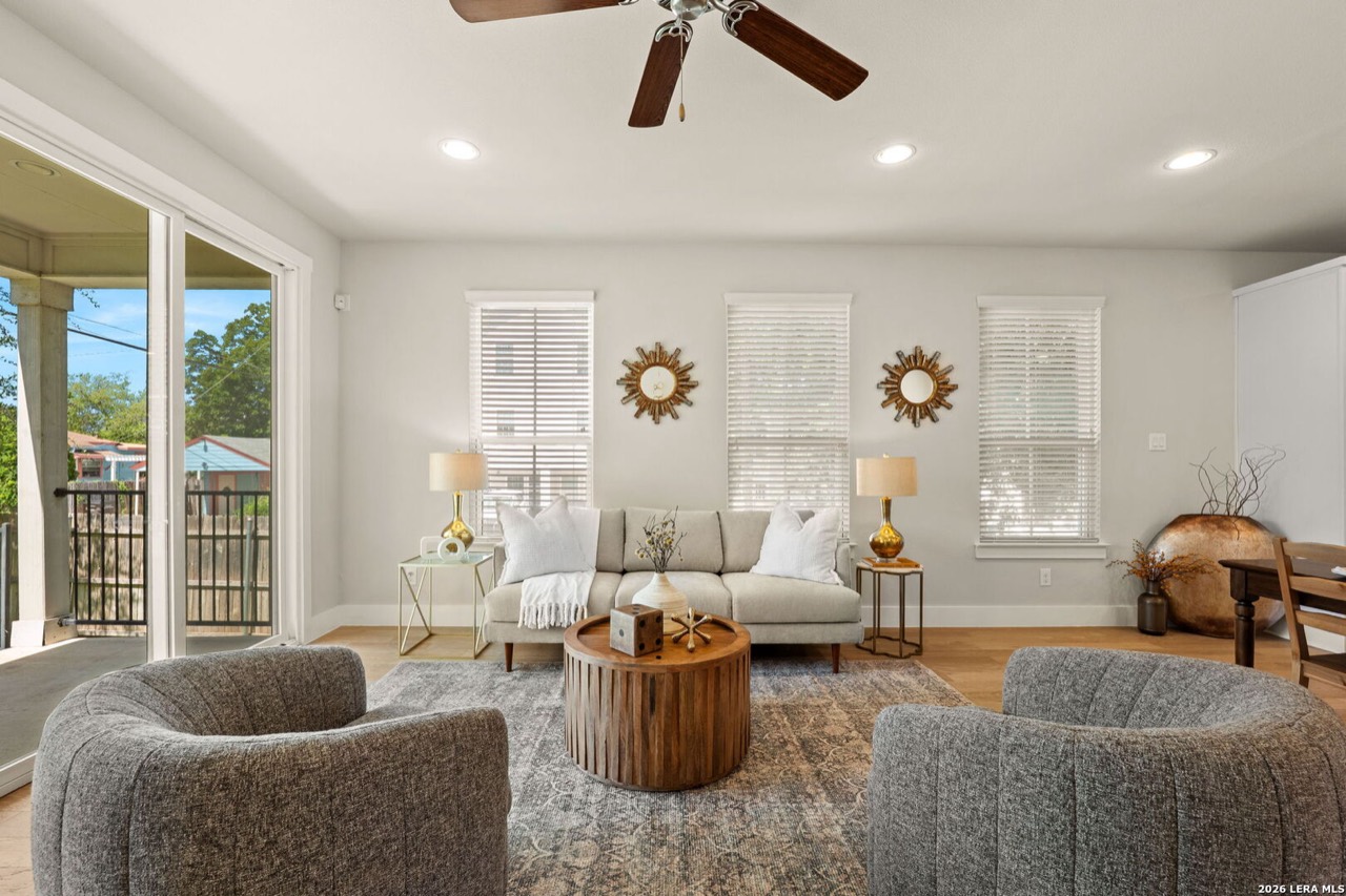 Staged living room with sunburst mirrors at 202 Claremont Ave #102