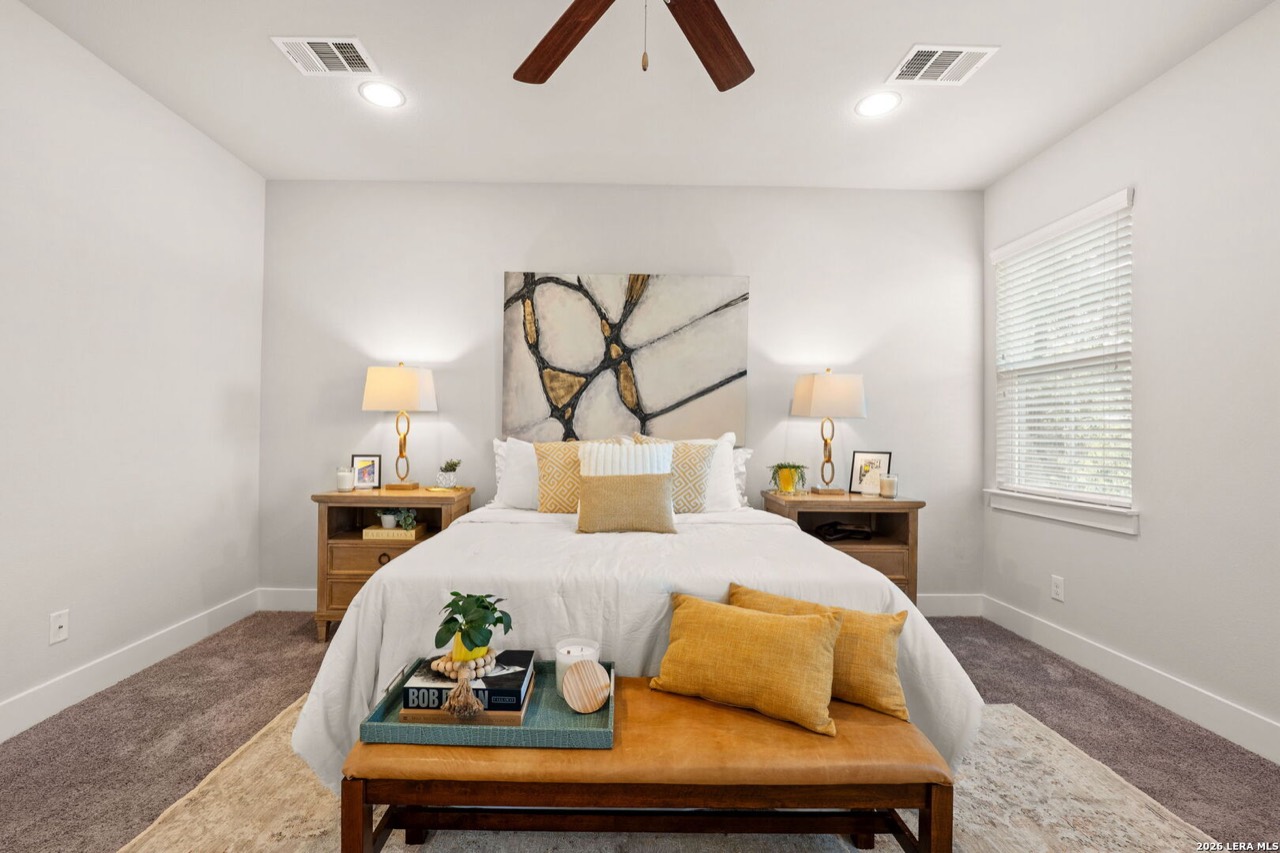 Staged primary bedroom with gold accents at 202 Claremont Ave #102