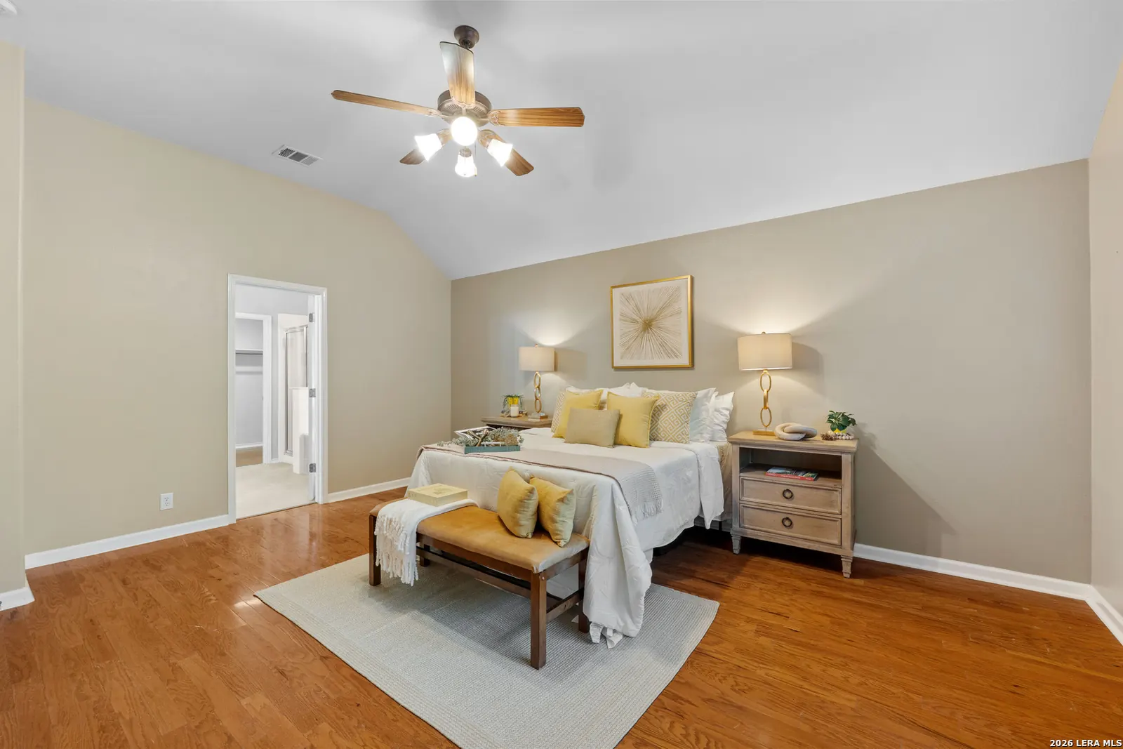 Bedroom staged with twin beds and yellow accent pillows